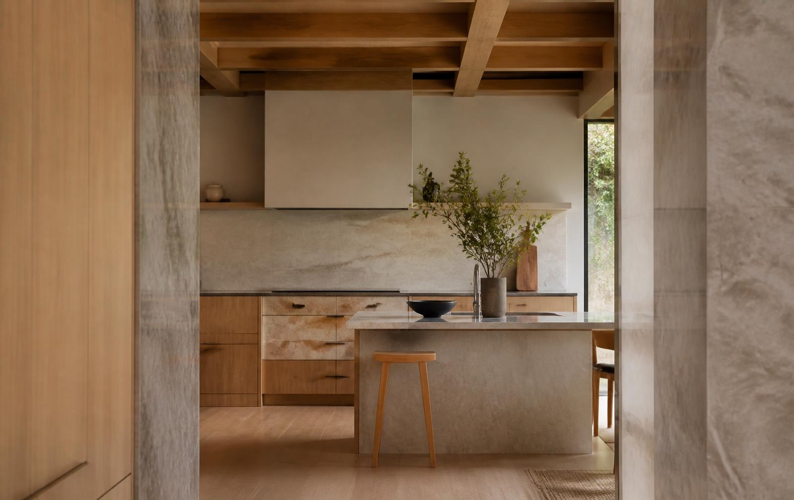 Renovated kitchen interior with stone island and timber joinery